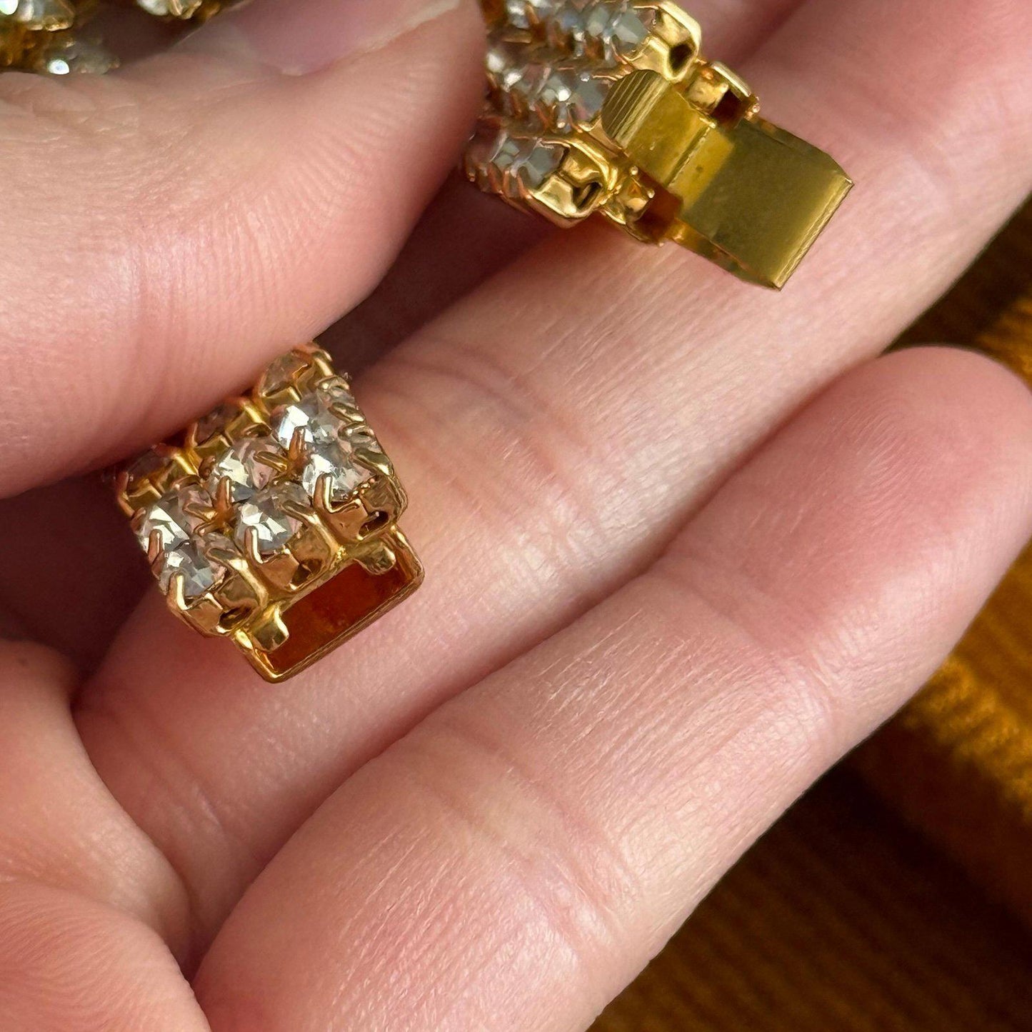 Gold-tone metal base with three rows of clear rhinestones bracelet