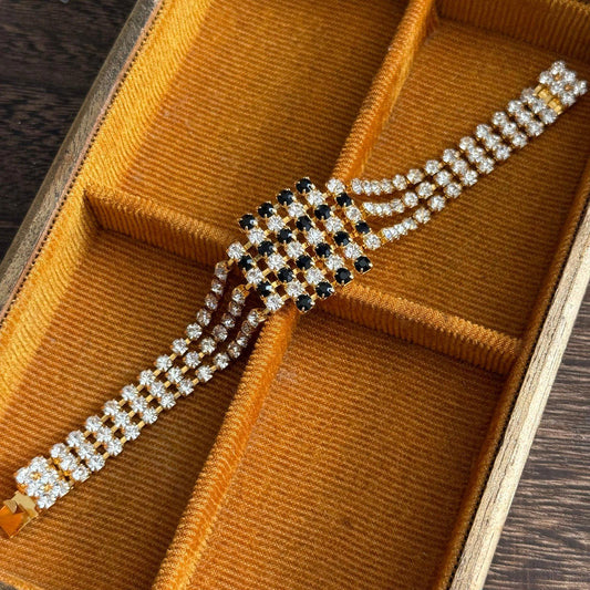 Gold-tone metal base with three rows of clear rhinestones bracelet