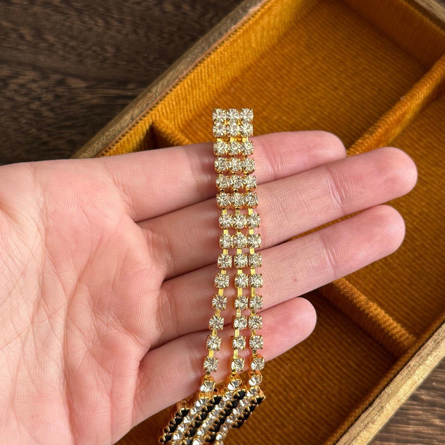 Gold-tone metal base with three rows of clear rhinestones bracelet