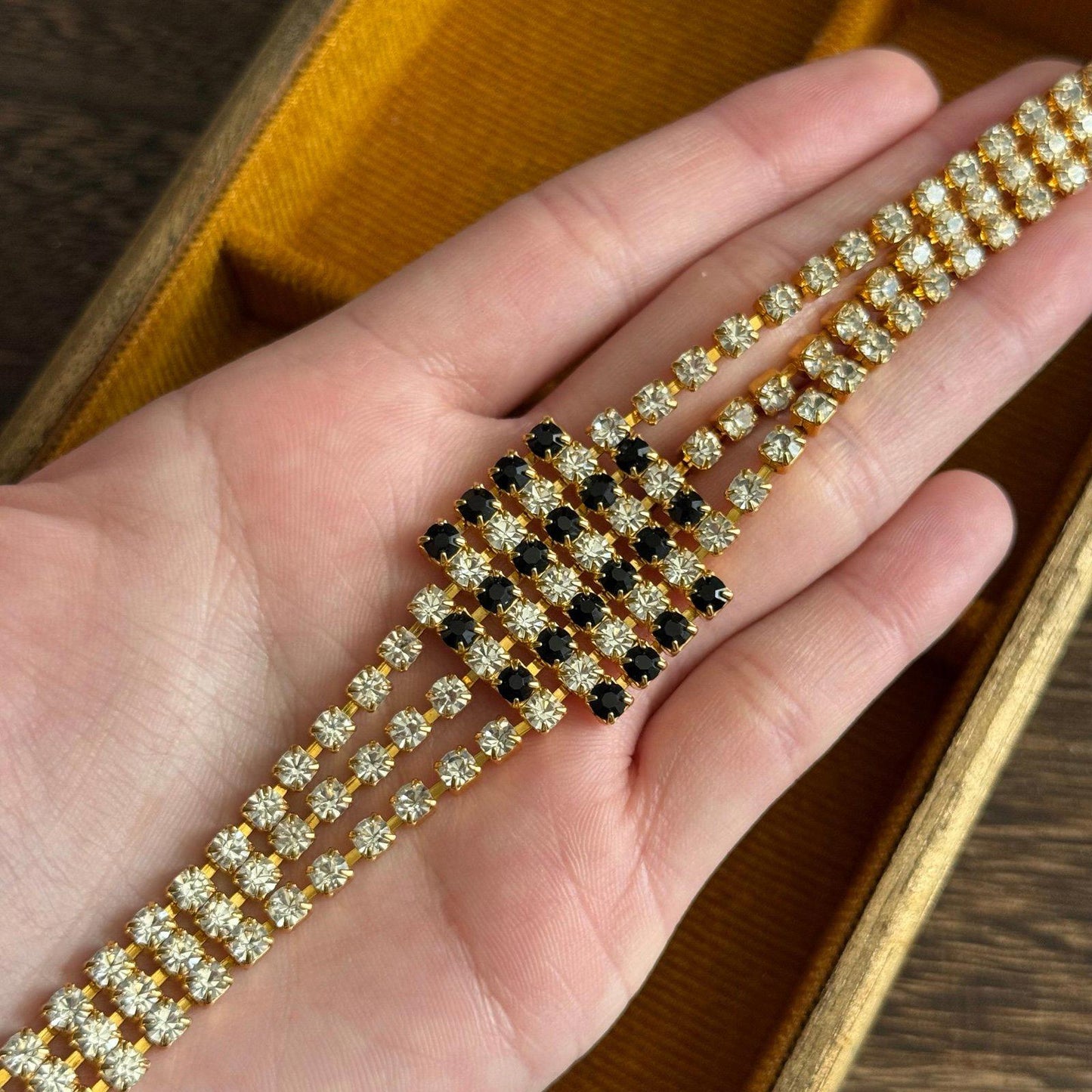 Gold-tone metal base with three rows of clear rhinestones bracelet