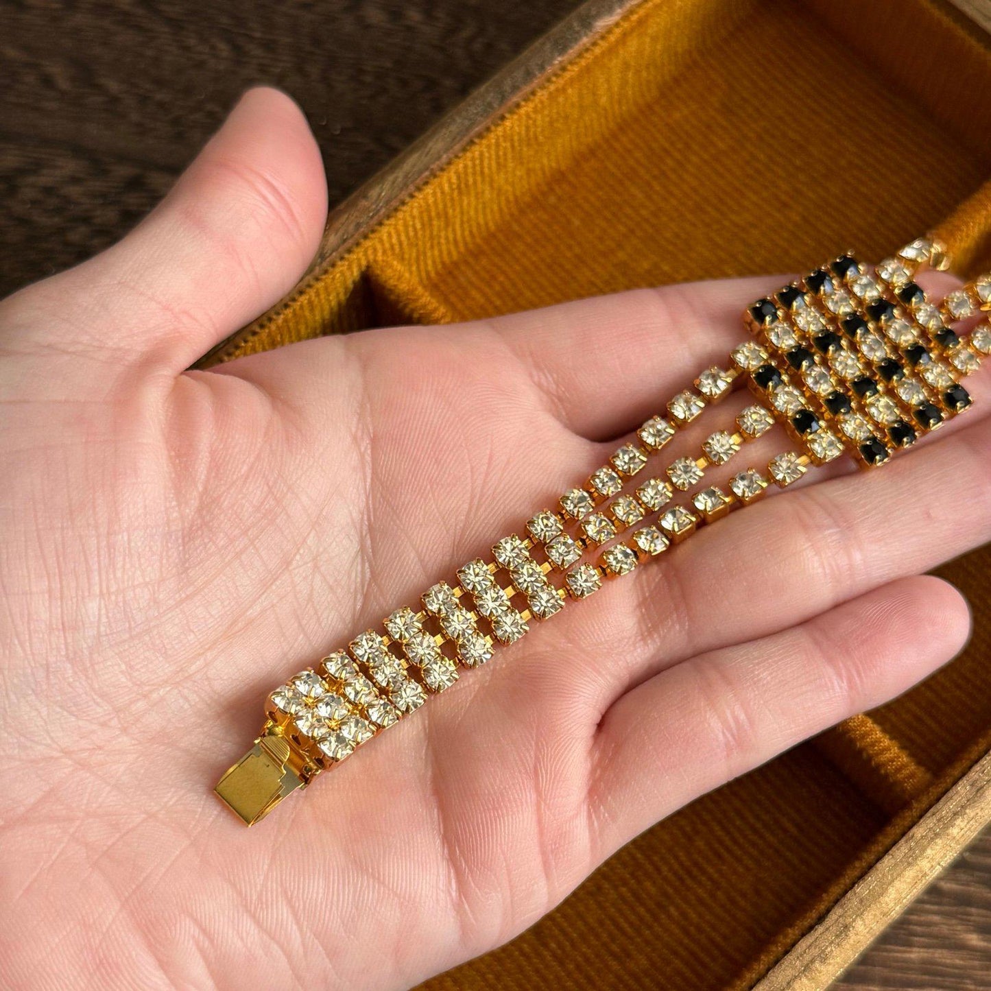 Gold-tone metal base with three rows of clear rhinestones bracelet