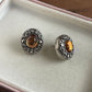 Vintage style silver tone oval orange stone earrings